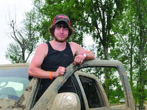 Spencerville's Jordan Healey stands in the cab of a 2005 Chevy pickup he uses for mudding at the Wheels A Churnin' motorsport event. (NICK GARDINER The Recorder and Times)