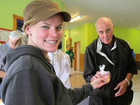Rebecca Foreshew, a health-care aide at Camp Trillium in Waterford, hands a cupcake to Gerry Retzer of Dundas, a member of the Independent Order of Odd Fellows Lodge 117. The camp held an open house Saturday for donors. (Daniel R. Pearce SIMCOE REFORMER)