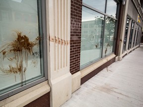 A brown, paint-like substance smears the front of the RBC and TD banks in downtown Kingston. It is believed to be part of a protest that took place Saturday evening. 
Sam Koebrich for The Whig-Standard