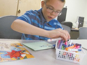 John Iverson, 12, of Mayerthorpe, draws a for a project in a session on Japanese culture in the Mayerthorpe Public Library Summer Reading Program. The program is led by Darsi Hall, the library’s C.A.P. (Community Access Program) youth intern.
\