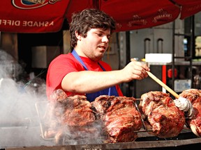 Mike Greey keeps a close eye on his barbecue during the 2012 Kinsmen Ribfest. This year's event will be Aug. 9 to 11 at Cockshutt Park. (Expositor file photo)