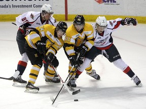 Kingston Frontenacs Sam Bennett (93) and Spencer Watson (96) battle for the puck with Windsor Spitfires Brady Vail (97) and Trevor Murphy (8) during Ontario  Hockey League action at the K-Rock Centre on Feb. 27. Bennett, Watson and Frontenacs teammate Roland McKeown have been named to the Canadian under-18 hockey team that will play in the Memorial of Ivan Hlinka tournament in Slovakia and the Czech Republic next week. (Ian MacAlpine/The Whig-Standard)