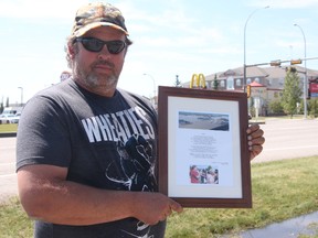 KEVIN RUSHWORTH HIGH RIVER TIMES/QMI AGENCY. High River resident Jeff Brewer wrote an inspirational poem about the triumphs and tragedies of the High River flood. All money from the proceeds of framed copies goes back to the Town of High River.