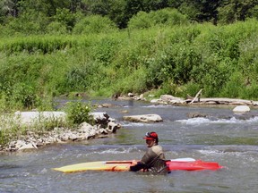 Paddleboard/Twitter expert Darryl Smart, photographer Bethanie Wood and videographer Jeff Tribe challenged the mighty Otter from Otterville to Rock’s Mills last Wednesday – and paid the price. Here, Smart recovers after an errant ‘surfing’ expedition near the former Rock’s Mills dam site. Bethanie Wood/Tillsonburg News Student Placement