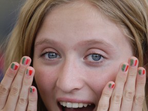 Victoria Stortini-Snider shows her Italian-flag-coloured finger nails during Sunday's Italian – Canadian Festival at the Roberta Bondar Pavilion. The annual event raises money for the ARCH Hospice and is put on by the Primavera Banquet Hall.