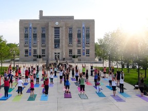 Local instructors Katrina Bos and Jennifer Reaburn are inviting experienced and new yogis to bring their mats to Rotary Cove for a free community yoga class, similar to this one held last month near the Huron County Courthouse. (Rob Boyce For the Signal Star)