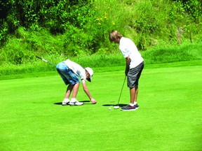 Owen Stebnitsky, right, practices his put before sinking the ball in the hole during the 2013 Kenora Golf and Country Club Championships. Stebnitsky won the junior division after shooting 194 over two days. 
PHOTO PROVIDED BY LORI STEBNITSKY