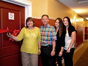 Linda and Steve Mangnall, along with daughters, cut the ribbon for the room they sponsored at Ronald McDonald House.