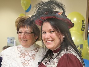 RBC employees Donna Ferguson, left, and Megan Horton dress in period costume to help the bank mark its 100th year in Kingston during a celebration at the Princess Street branch Tuesday morning.
Michael Lea The Whig-Standard