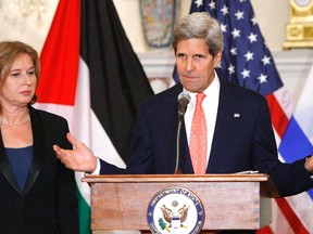 U.S. Secretary of State John Kerry announces further peace talks at a news conference with Israel's Justice Minister Tzipi Livni, left, and chief Palestinian negotiator Saeb Erekat, right, at the State Department in Washington on July 30, 2013. (REUTERS/Jonathan Ernst)