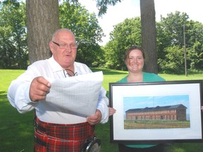 Dave Phillips, Elgin county's Town Crier, reads a cry written by Angela Bobier, right, cultural manager of the Backus-Page House Museum. Bobier won a contest to compose a cry that Phillips will use at a World Invitational Town Crier competition in Kingston.