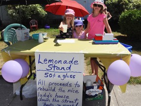 Shae Gordon, 9, Mikaya Ellis, 4, and Stevie Ellis, 9, sell lemonade to help Front Street North neighbour Dianne Grills repair her home, damaged when a vehicle crashed into it Feb. 14. See story on page 3. 
Mark Hoult Community Press
