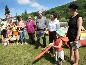 Nipissing First Nation Chief Marianna Couchie, left, New Democrats Nickel Belt MP Claude Gravelle and Trinity-Spadina MP Olivia Chow, Nipissing University history professor Catherine Murton-Stoehr and her five-year-old daughter, Addie Murton, at an event Tuesday at Olmsted Beach to rally for the protection of Trout Lake.