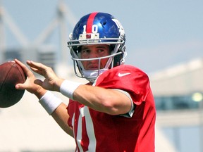 New York Giants quarterback Eli Manning throws during a training camp drill Tuesday in East Rutherford, N.J. (JOHN KRYK/QMI Agency)