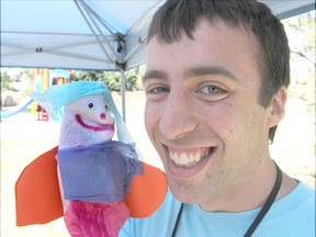 Mobile arts team member Nick Denis holds a sock puppet made by one of the children taking part in a summer arts program that is now in its second year. The team goes around to different parks and community centres to expose both children and adults to different forms of artistic expression.
Michael Lea The Whig-Standard