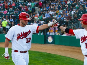 Winnipeg Goldeyes Josh Mazzola (right) congratulates teammate Casey Hearther on his third-inning home run in Game 1 of an American Association baseball doubleheader, Tuesday, July 30, 2013 at Shaw Park in Winnipeg. Winnipeg defeated the Lincoln Saltdogs 8-0 in Game 1 and 12-2 in Game 2. Photo by Shawn Coates.