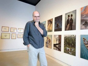 Scott McKowen is shown with some of the illustrations featured in his solo exhibition at the Gallery Stratford entitled Light Revealed. (SCOTT WISHART, The Beacon Herald)
