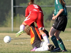 A Belleville U12 Comets player runs over the Quinte West Wolverines goalkeeper in a 10-0 Belleville whitewash last Thursday at Trenton's Centennial Park.