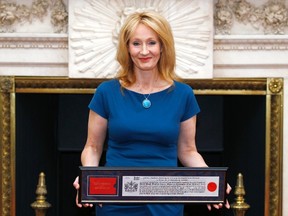 Author J.K. Rowling poses for photos with her certificate at Mansion House after being presented with the Freedom of the City of London May 8, 2012.  REUTERS/Andrew Winning