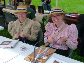 Historic Dunvegan Parks interpreters Annette Vandekerkhove (left) and Stephanie McLachlan demonstrate crocheting and finger weaving during 2012’s Fresh Air Market.
