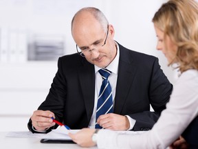 A businesswoman obtains some financial advice. (Fotolia.com)