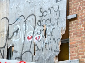 A 19-year-old woman is charged with mischief and three youths were sent by Owen Sound police to complete a program after police linked graffiti almost all behind the former Strathcona school to them. (Scott Dunn/The Sun Times Owen Sound)