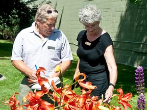 Ted Zarudney of Orangeville, Ontario and Lorna Mcilroy of Grand Prairie, Alberta adjudicate Pincher Creek’s effort in the 2013 Communities in Bloom competition. File Photo.