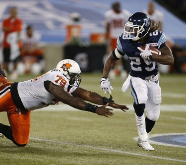Toronto Argos defeat the BC Lions in CFL football 38-12. Toronto Argonauts' Curtis Steele runs for a gain in the 4th quarter in Toronto on Wednesday July 31, 2013. (Michael Peake/Toronto Sun)
