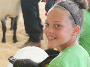 Ashley Corbiere poses for a photo with her sheep, which won her a 2nd place ribbon in the show.