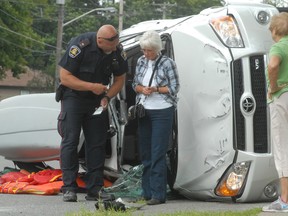 Const. Joe Poderys speaks with a woman following a two-vehicle collision at Willow Avenue and Tilley Road on Wednesday afternoon. A Toyota Rav4 was on its side with camping supplies strewn on Willow.