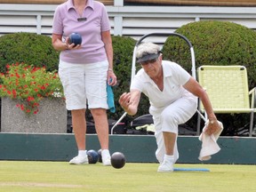 Murial LaPlante, right, of the Simcoe Lawn Bowling Club bowls on the green while competitor Laura Ritchie from St. George watches on during the Bonnieheath Lavender Ladies Pair Tournament in 2013. (EDDIE CHAU Simcoe Reformer)