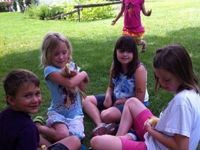 Kids get to know some ducks, who will also be appearing at the Summer Fete on Aug. 11, at Adelaide Hunter Hoodless Homestead during a recent summer camp. SUBMITTED PHOTO