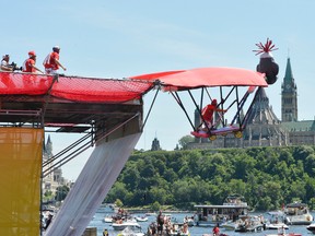 Ken Edgar of Paris takes flight in Team Sock Monkey's homemade flying machine over the Ottawa River during the Red Bull Flugtag event at the Museum of Civilization in Gatineau, Que., on Saturday, July 27, 2013. The team came in fifth place with a distance of 39 feet flown. MATTHEW USHERWOOD/QMI Agency
