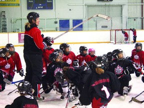 Three-time Olympic medalist Sami Jo Small points with her hockey stick to explain the next drill during her Sami Jo Small Female Hockey School taking place this week at the Keewatin Memorial Arena.