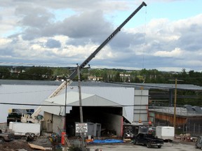 A crane is seen operating along the Mattagami River where the Eacom Timber sawmill is being reconstructed. Eacom has invested about $25 million to rebuild the mill which was destroyed by fire in January 2012.