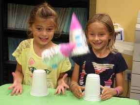 Maija McCord, left, and Kendra Shortt were at the Timmins Museum: National Exhibition Centre Wednesday where they designed their own rockets that popped up in the air. The six-year-old friends were among the children participating in a space-themed educational program that continues next week at the museum.