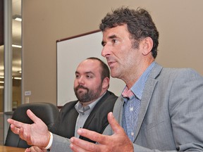 Marc Laferriere (left), the NDP candidate in the last federal election, listens as NDP MP Paul Dewar speaks during an interview at The Expositor on Wednesday. (Brian Thompson, The Expositor)