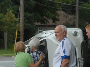 A woman is comforted following a two-vehicle collision at the intersection of Willow Avenue and Tilley Road on Wednesday, July 31, 2013.
