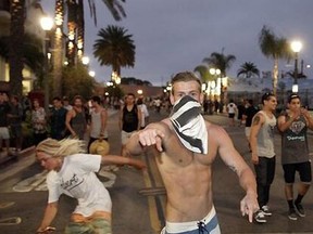 Riots erupted after the U.S. Surf Open Sunday in Huntington Beach, Calif.