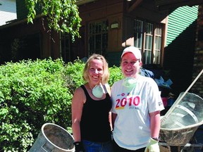 Aylisa Eldridge and Ainsley Toomey stand outside a home they helped clean up during their visit on Sunday, June 30. Photo supplied.