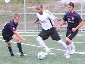 Micael N'Goran of SS Mobile Auto splits a pair of Blood, Sweat and Beers defenders in Nipissing District Adult Soccer League men's second division action Monday as the teams played to a scoreless draw.

DAVE DALE/THE NUGGET/QMI AGENCY