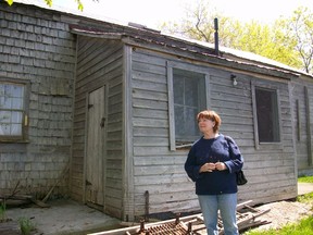 The late Victoria Stewart, founder of the Wolfe Island Historical Society, stands outside the 'Old House.'