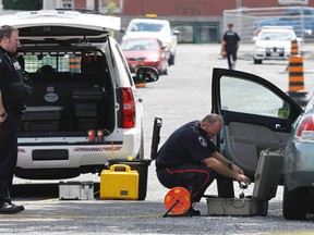 Belleville police officers investigate a motor vehicle collision on Boswell Street, north of Moira Street in Belleville, where a two-year old child was struck by a car around 10:30 a.m. Thursday, Aug. 1, 2013. - JEROME LESSARD/The Intelligencer