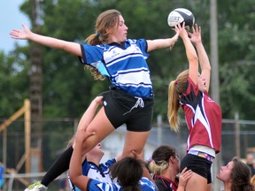 Kelsey Smith (right) of the Norfolk Harvesters catches the ball during a home game against the Waterloo County Rugby Club Wednesday night in Waterford. Waterloo defeated Norfolk 42-5.