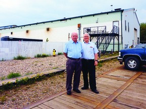 Dave Drader (right) stands outside of the old Drader Manufacturing building with past manager Phil Rogers in June. The building, located southwest of The Sherwood Park Freeway and Highway 216 interchange, is slated to be torn down as part of the Anthony Henday ring road northeast expansion just west of Sherwood Park. Photo Courtesy Dave Drader