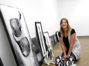 Candace Hook, executive director for the Centre for Creative Arts shows off some of the artwork that will be featured in the CCA’s upcoming Black and White exhibit. (Kirsten Goruk/Daily Herald-Tribune)