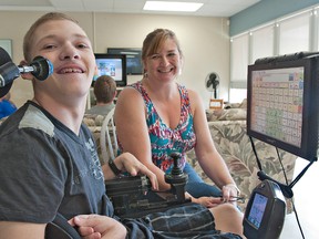 Nathan Manners, 17, uses the joystick controller that normally navigates his power wheelchair to create words that the computer vocalizes to communicate with others.  Nathan is attending a Self Care Independent Living for Life camp led by Linda Field-Newhouse, family services co-ordinator at Lansdowne Children's Centre in Brantford. (Brian Thompson, The Expositor)