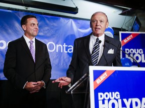 Ontario PC Leader Tim Hudak (left) beams as Doug Holyday gives his acceptance speech after winning the byelection in Etobicoke-Lakeshore on Aug. 1. (ERNEST DOROSZUK, Toronto Sun)
