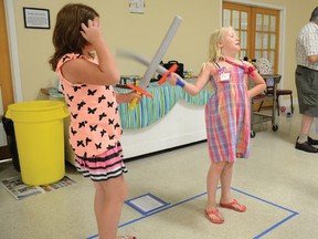 Breah Demers, 9, left, and Milla Fox-Tippet, 8, engage in a slightly safer, foam-based version of the time-honoured art of fencing during St. Luke's first annual Vacation Bible School day camp last week.