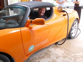 Christopher Misch, vice-president of Sun Country Highway, showed off the new fully-electric Tesla Roadster at Leader Resources on July 31, 2013. He will be visiting numerous municipalities to get the conversation started about green transportation. (ALANNA RICE/KINCARDINE NEWS)